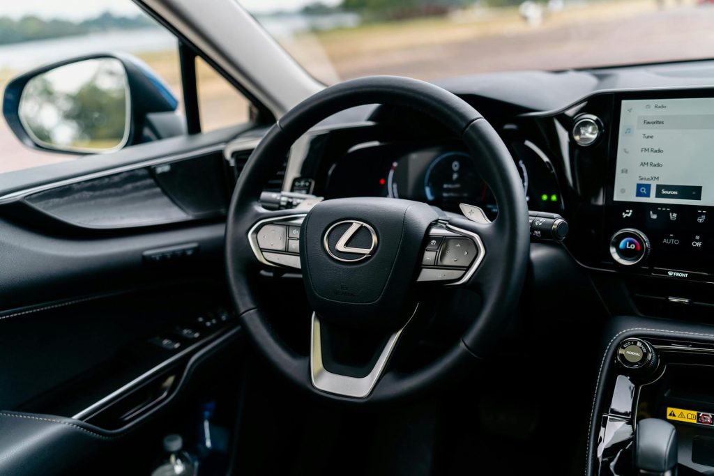 Detailed view of a Lexus car interior focusing on the steering wheel and dashboard.