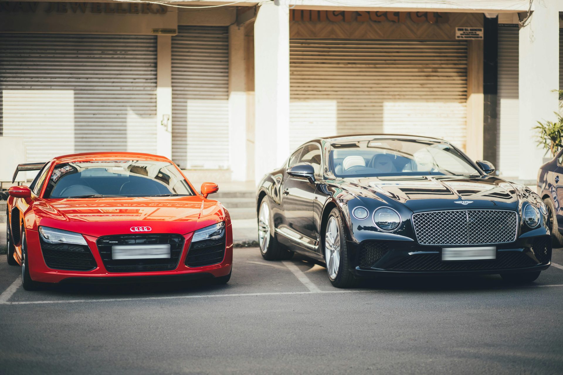 Audi R8 and Bentley Continental GT showcased in a Chandigarh parking area, capturing luxury car elegance.