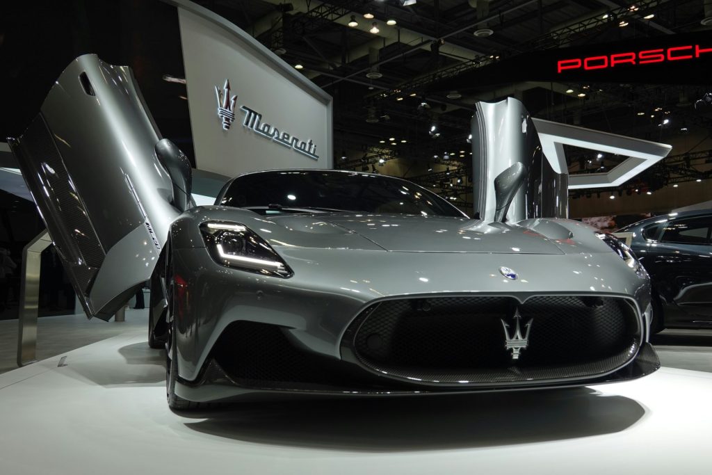 a silver sports car is on display at a car show