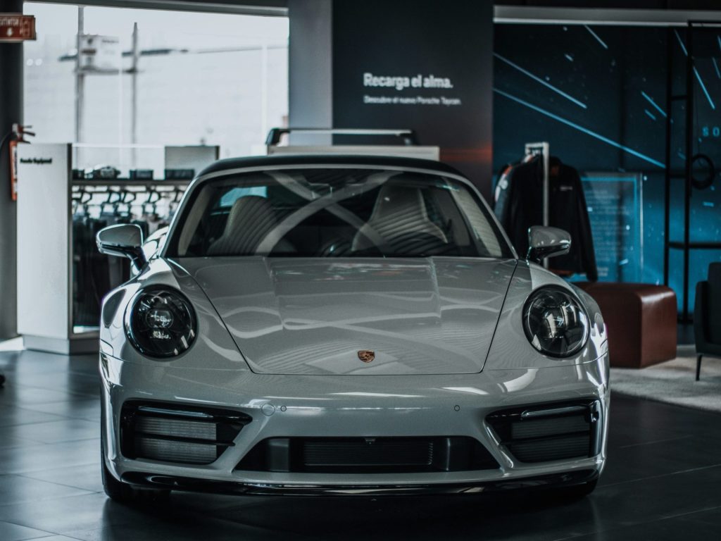 a white sports car parked in a showroom